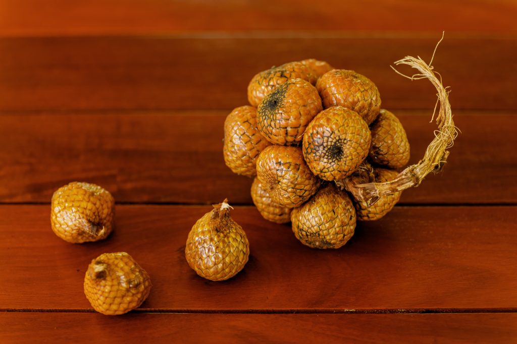 Wild salak fruit on wooden table
